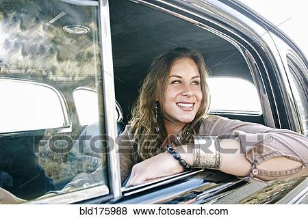 Mixed race woman driving vintage car View Large Photo Image Stock Photo - Mixed race woman driving vintage car. Fotosearch