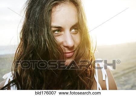 Stock Photo - Mixed race woman smiling on beach. Fotosearch