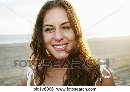 Stock Photograph - Mixed race woman smiling on beach. Fotosearch