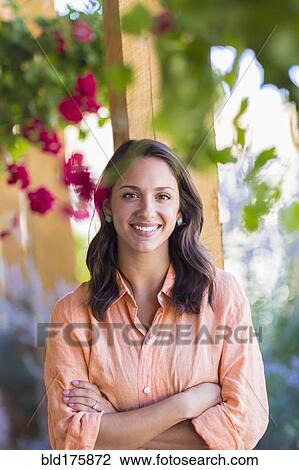 Stock Image - Mixed race woman smiling outdoors. Fotosearch