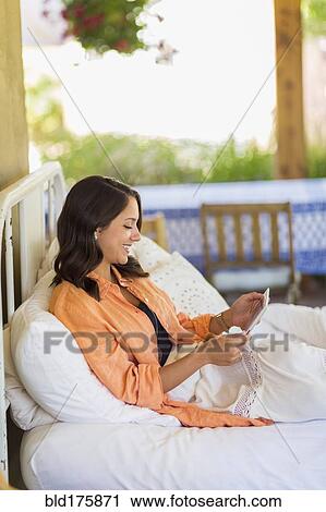 Stock Image - Mixed race woman using digital tablet. Fotosearch