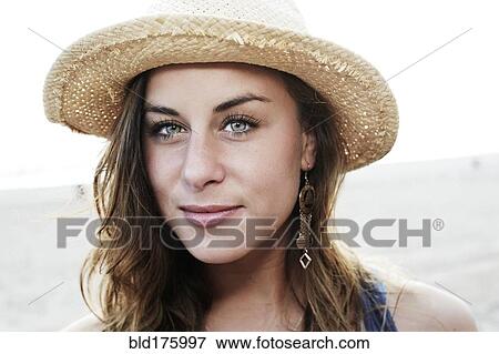 Mixed race woman wearing straw hat View Large Photo Image Stock Photo - Mixed race woman wearing straw hat. Fotosearch