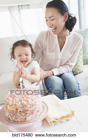 Mother and baby daughter celebrating birthday View Large Photo Image Stock Image - Mother and baby daughter celebrating birthday. Fotosearch