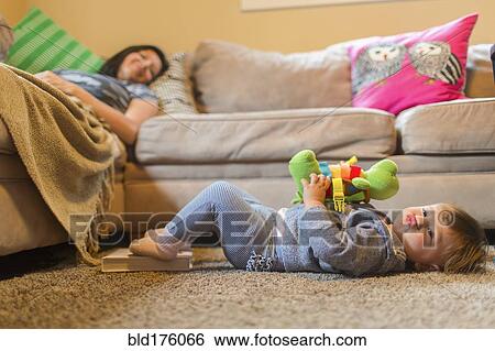 Mother and baby daughter relaxing in living room View Large Photo Image Stock Photograph - Mother and baby daughter relaxing in living room. Fotosearch