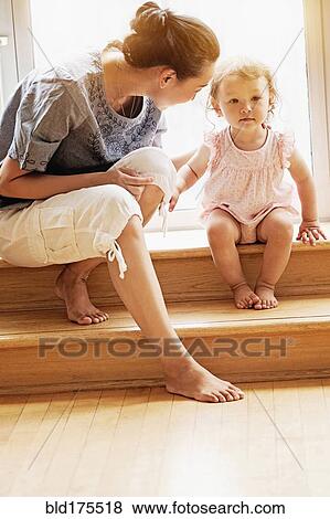 Mother and baby daughter sitting on steps View Large Photo Image Stock Photo - Mother and baby daughter sitting on steps. Fotosearch