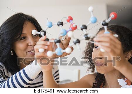 Stock Image - Mother and daughter examining molecular model. Fotosearch