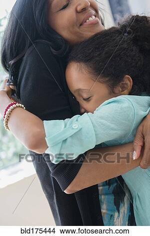 Mother and daughter hugging View Large Photo Image Picture - Mother and daughter hugging. Fotosearch
