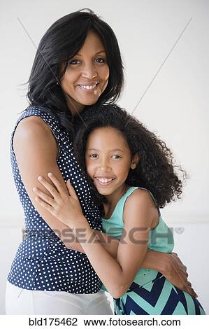 Stock Image - Mother and daughter hugging. Fotosearch