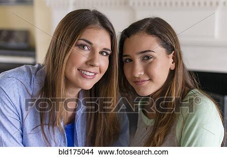 Mother and daughter smiling indoors View Large Photo Image Picture - Mother and daughter smiling indoors. Fotosearch