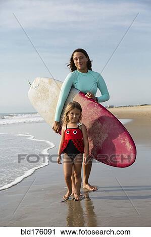 Mother and daughter smiling on beach View Large Photo Image Stock Image - Mother and daughter smiling on beach. Fotosearch