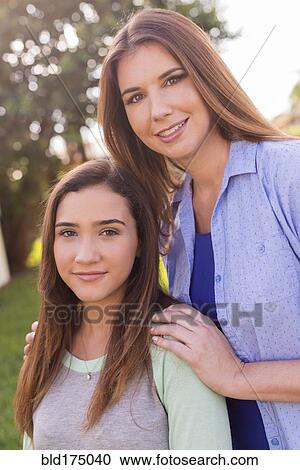 Stock Image - Mother and daughter smiling outdoors. Fotosearch