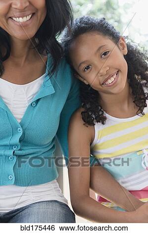 Mother and daughter smiling View Large Photo Image Stock Photograph - Mother and daughter smiling. Fotosearch