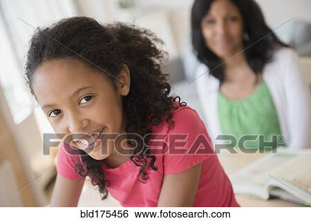 Stock Photograph - Mother and daughter smiling. Fotosearch