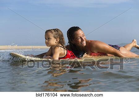 Mother and daughter surfing View Large Photo Image Picture - Mother and daughter surfing. Fotosearch