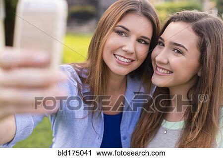 Mother and daughter taking selfie outdoors View Large Photo Image Stock Image - Mother and daughter taking selfie outdoors. Fotosearch