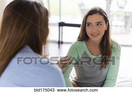 Mother and daughter talking indoors View Large Photo Image Stock Image - Mother and daughter talking indoors. Fotosearch