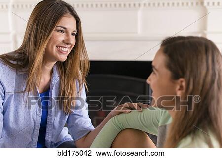 Mother and daughter talking near fireplace View Large Photo Image Stock Image - Mother and daughter talking near fireplace. Fotosearch