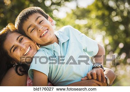 Stock Photo - Mother and son hugging outdoors. Fotosearch