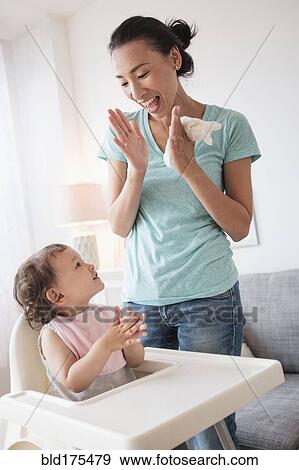 Mother clapping with baby daughter View Large Photo Image Stock Photo - Mother clapping with baby daughter. Fotosearch