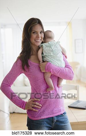 Stock Photo - Mother holding baby daughter. Fotosearch