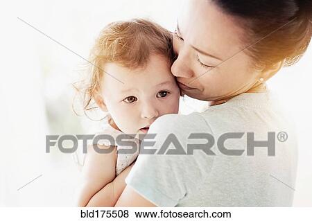 Stock Photo - Mother holding baby daughter. Fotosearch