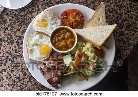 Stock Photo - Plate of beans, egg, toast and salad. Fotosearch