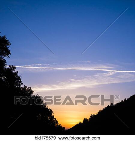 Silhouette of hills under sunrise sky View Large Photo Image Stock Photo - Silhouette of hills under sunrise sky. Fotosearch