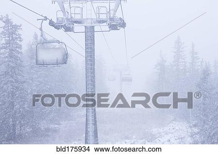 Picture - Ski lift on snowy hillside. Fotosearch
