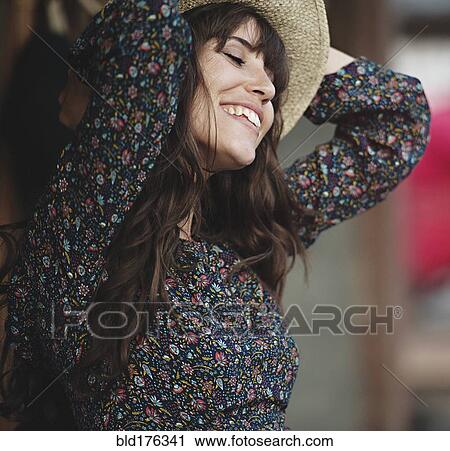Stock Image - Smiling Caucasian woman dancing outdoors. Fotosearch