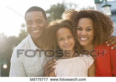Smiling family standing outdoors View Large Photo Image Stock Photo - Smiling family standing outdoors. Fotosearch