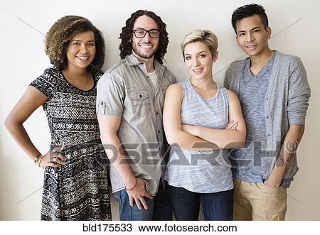Smiling friends standing in a row View Large Photo Image Stock Image - Smiling friends standing in a row. Fotosearch