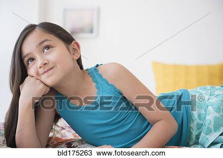 Smiling girl daydreaming with chin in hand View Large Photo Image Stock Image - Smiling girl daydreaming with chin in hand. Fotosearch
