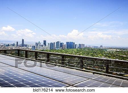 Solar panels and Manila cityscape under blue sky, Philippines View Large Photo Image Picture - Solar panels and Manila cityscape under blue sky, Philippines. Fotosearch