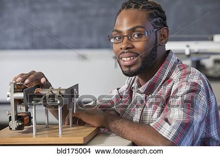 Picture - Student performing experiment in science classroom. Fotosearch