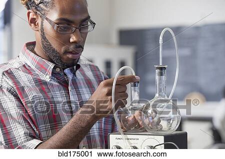 Student performing experiment in science classroom View Large Photo Image Stock Image - Student performing experiment in science classroom. Fotosearch