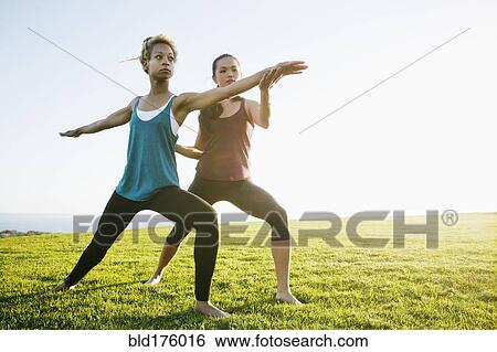 Teacher helping student practice yoga outdoors View Large Photo Image Stock Photograph - Teacher helping student practice yoga outdoors. Fotosearch