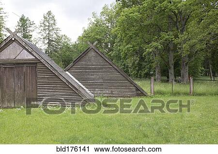 Stock Image - Traditional wooden buildings in field. Fotosearch