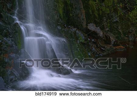Stock Photo - Waterfall flowing over rocky cliff. Fotosearch