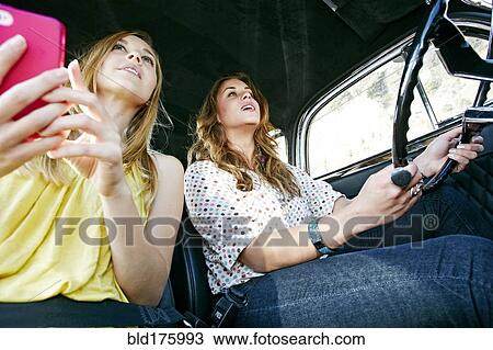 Women driving vintage car View Large Photo Image Stock Image - Women driving vintage car. Fotosearch