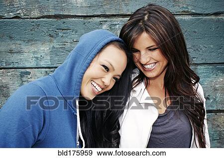 Women laughing at wooden wall View Large Photo Image Stock Photo - Women laughing at wooden wall. Fotosearch