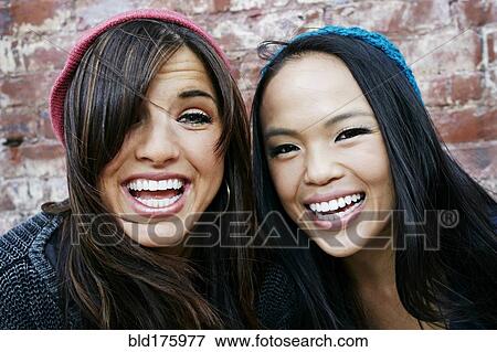 Women laughing in front of brick wall View Large Photo Image Stock Photo - Women laughing in front of brick wall. Fotosearch