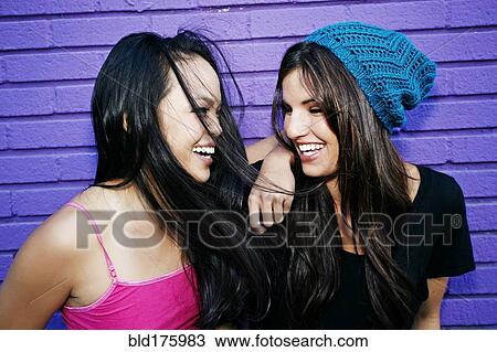 Women laughing near purple brick wall View Large Photo Image Stock Image - Women laughing near purple brick wall. Fotosearch
