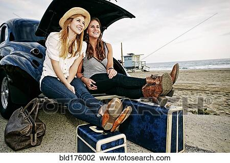 Women with luggage and vintage car on beach View Large Photo Image Stock Image - Women with luggage and vintage car on beach. Fotosearch