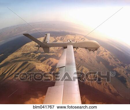 Aerial view of drone flying over desert landscape View Large Photo Image Stock Photo - Aerial view of drone flying over desert landscape. Fotosearch