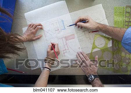 Stock Photo - Architects working on schematics. Fotosearch