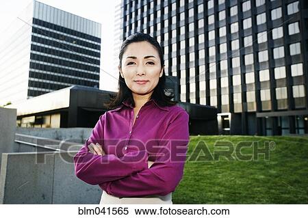 Asian businesswoman standing outdoors View Large Photo Image Stock Photography - Asian businesswoman standing outdoors. Fotosearch