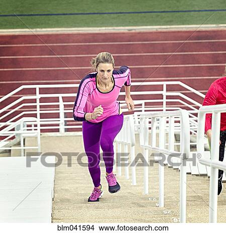 Picture - Athlete running up bleachers. Fotosearch