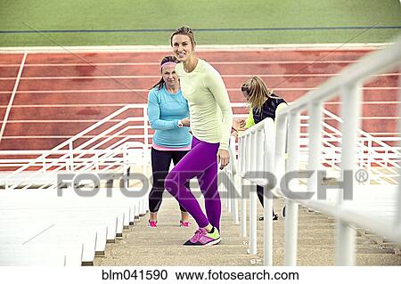 Athletes standing on bleachers View Large Photo Image Stock Image - Athletes standing on bleachers. Fotosearch
