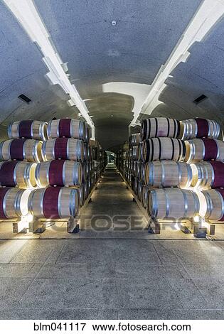 Stock Photo - Barrels of wine aging in wine cellar. Fotosearch
