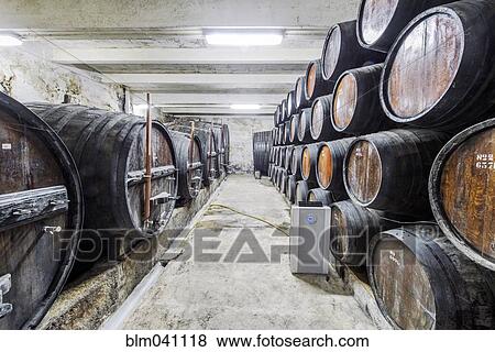 Barrels of wine aging in wine cellar View Large Photo Image Stock Photo - Barrels of wine aging in wine cellar. Fotosearch